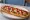 Zapiekanka z Ketchupem: an illustration of mushroom, cheese, onion and ketchup.
