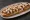 Zapiekanka z Kurczakiem: an illustration of chicken, mushroom, cheese, onion and more.