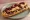 Zapiekanka z Oscypkiem: an illustration of mushroom, onion and cranberry sauce.