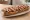 Zapiekanka z Plac Nowy: an illustration of mushroom, cheese, onion, ketchup and more.