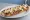 Zapiekanka z Sosem Czosnkowym: an illustration of mushroom, cheese, onion, garlic and more.