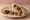 Zeitoun (زيتون): an illustration of olives and olive oil on pita.